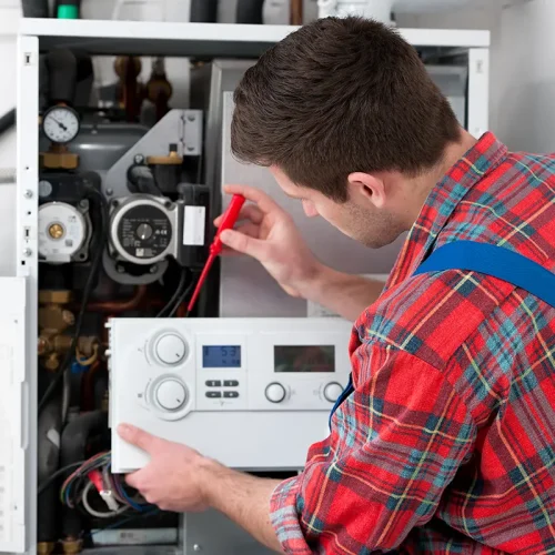 man repairing the boiler