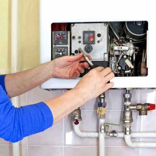 man repairing the boiler